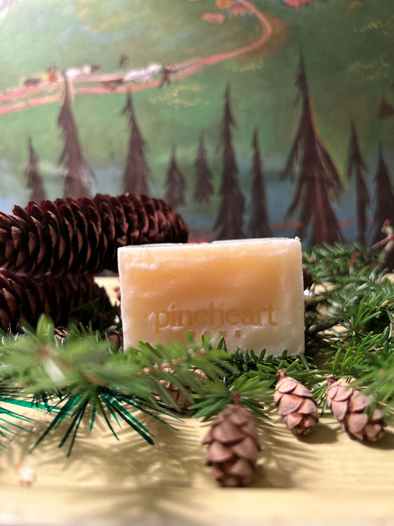 Alternate view of Fraser Fir soap unwrapped and surrounded by tiny pinecones.